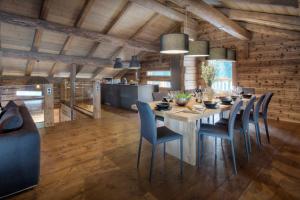 a dining room with a table and chairs at Chalet Victorina - OVO Network in La Giettaz