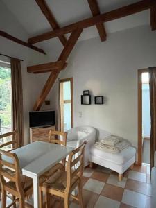 a living room with a table and a couch at Kaiserhof Goldenbek in Goldenbek