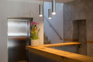 a bathroom with a counter with a vase with flowers in it at Hotel Herrnbrod & Ständecke in Dreieich