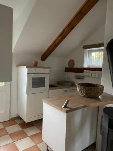 a kitchen with white appliances and a counter top at Kaiserhof Goldenbek in Goldenbek