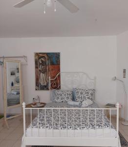 a white bed in a white room with at Barud Gedera Israel in Gedera