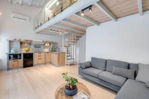 a living room with a couch and a table at Nomade vibrant living loft in Ermoupoli