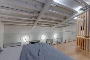 a large room with white walls and white ceilings at Nomade vibrant living loft in Ermoupoli