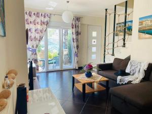 a living room with a couch and a table at Villa Vision in Skala Potamias
