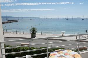 a view of a beach with boats in the water at Les Stoechades in Hyères