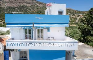 a house with a blue and white facade at Studios Eftihia in Keratokampos