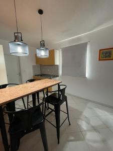 a dining room with a table and chairs and two lights at Sunset Villa Hvar in Hvar