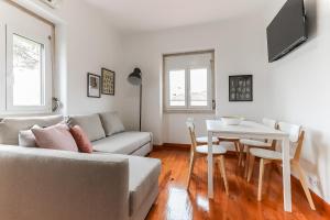 a living room with a couch and a table at Nine Horizons Belém in Lisbon
