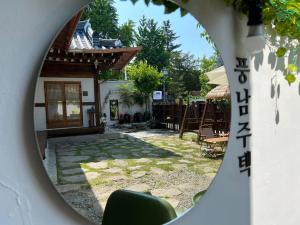 a view of a house through a circular mirror at Pungnam House in Jeonju