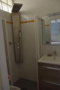 a bathroom with a shower and a sink at Les Stoechades in Hyères
