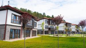 a row of houses with trees in the yard at Ortel Inn in Ordu