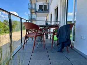 a balcony with a table and chairs on a house at Haus Zudar / Prora in Binz