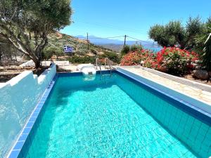 - une piscine avec du carrelage bleu dans l'établissement Beautiful Villa Helios with stunning sea view!, à Vrouchas