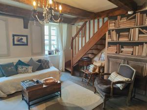 a living room with a couch and a staircase at Ty Brigitte in Dinan +2 photos