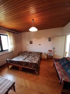 a bedroom with a large bed and a wooden ceiling at Norma 3 in Novigrad Istria