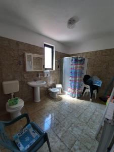 a bathroom with a sink and a toilet and a shower at Norma 3 in Novigrad Istria
