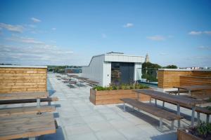 a row of wooden benches sitting on top of a roof at Studios and Private Bedrooms with Shared Kitchen at Canvas Bristol near the City Centre in Bristol