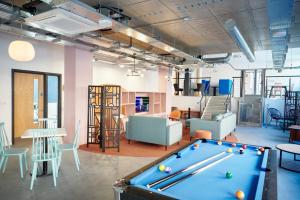 a billiard room with a pool table and chairs at Studios and Private Bedrooms with Shared Kitchen at Canvas Bristol near the City Centre in Bristol