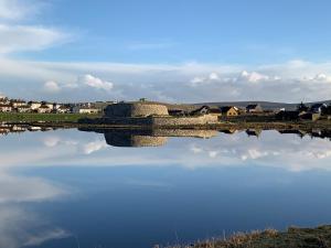 a bridge over a body of water with houses in the background at Islesburgh House Hostel in Lerwick