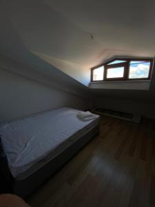 a small bedroom with a bed and a window at 4+1 DUBLEX LUX FLAT IN SULTAN SELIM in Istanbul