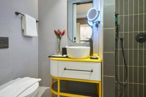 a bathroom with a sink and a mirror at Citadines Connect City Centre Singapore in Singapore