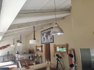 a dining room with wooden beams and a table at maison d'hôtes 2 personnes les deux esprits libres in Claira