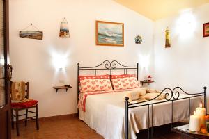a bedroom with a bed with red pillows at Agriturismo Bocci in Castiglione della Pescaia