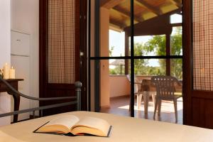 an open book on a table in a room with a porch at Agriturismo Bocci in Castiglione della Pescaia