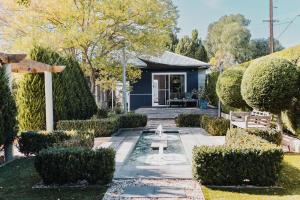 a garden with a fountain in front of a house at S T U D I O 22 Peaceful Retreat with Garden Views in Port Lincoln