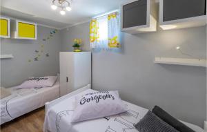 a room with two beds and a tv in it at 2 Bedroom Stunning Home In Sisan in Šišan