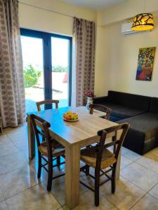 a dining room table with a bowl of fruit on it at Villa Alexander 2 in Triopetra +8 photos
