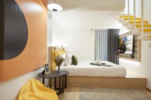 a hotel room with a bed and a table at Citadines Connect City Centre Singapore in Singapore