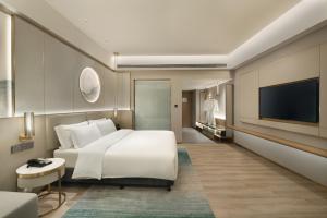 Voodi või voodid majutusasutuse Shenzhen Grand Skylight Garden Hotel toas