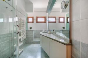 a bathroom with a sink and a shower at Prospettiva Corso Giovecca apartment in Ferrara +21 photos