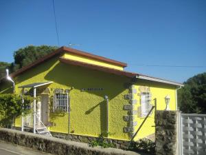 a yellow building with a fence in front of it at La Rocalla del Tiétar in Sotillo de la Adrada