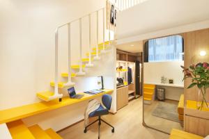 an office with a desk and a staircase at Citadines Connect City Centre Singapore in Singapore