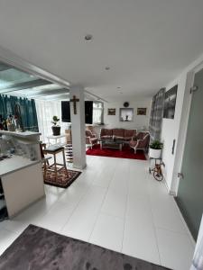 a living room with white tile floors and a living room at Villa Dijamant in Harthausen
