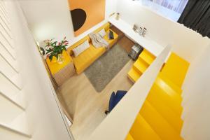 an overhead view of a living room with a yellow couch at Citadines Connect City Centre Singapore in Singapore