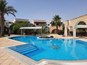 a large blue swimming pool in a courtyard at Sunrise Beach Suite B7 in Kalecik