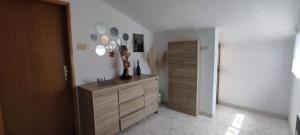 a room with a dresser with a bunch of mirrors on the wall at Apartment Eva in Rovinjsko Selo