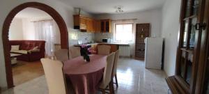 a kitchen and dining room with a table and a refrigerator at Apartment Eva in Rovinjsko Selo