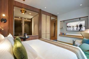 a hotel room with a bed and a television at Citadines Connect City Centre Singapore in Singapore