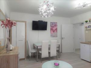 a kitchen and dining room with a table and chairs at City Lux Apartments in Skopje