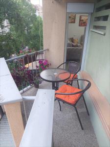 a patio with a table and chairs on a balcony at City Lux Apartments in Skopje