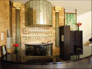 a room with a table and a wall with wine glasses at Smart Accommodation Rhodes in Rhodes Town