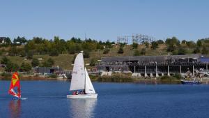 two small sailboats on a lake with people on it at Ferienwohnung Schöne Auszeit in Markkleeberg