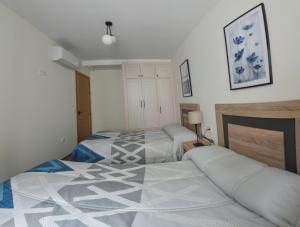 Posteľ alebo postele v izbe v ubytovaní Apartamentos Turísticos Hornillo AT-CC-00681