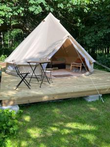 a tent with a table and chairs on a deck at Prostens Bed & Breakfast in Getinge