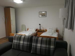 a living room with two beds and a couch at 21a Comfortable Studio in Taufkirchen