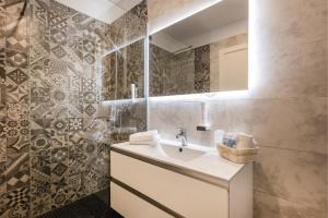 a bathroom with a sink and a mirror at Hotel De Nac in Nago-Torbole